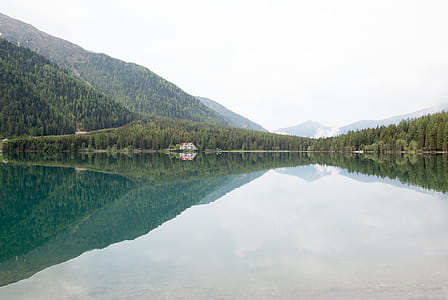 Photograph of Calm Body of Water and Mountain Ranges thumbnail