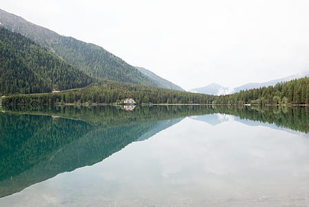 lake near forest surround mountains thumbnail