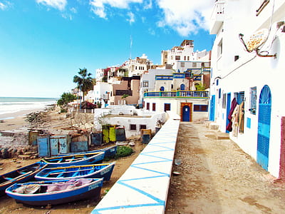 boats near blue and white building thumbnail