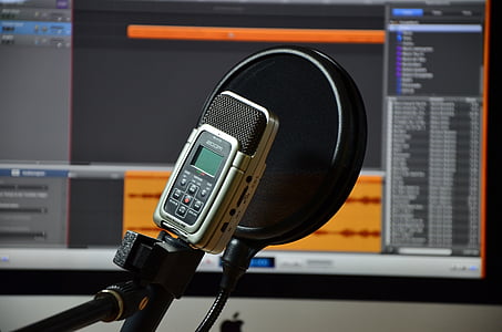 grey and black condenser microphone with pop filter inside room thumbnail