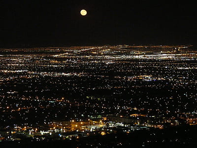 black and white city during nighttime under full moon thumbnail
