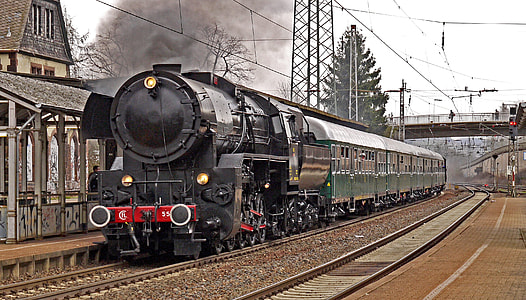 black locomotor train near brown wooden waiting shed thumbnail