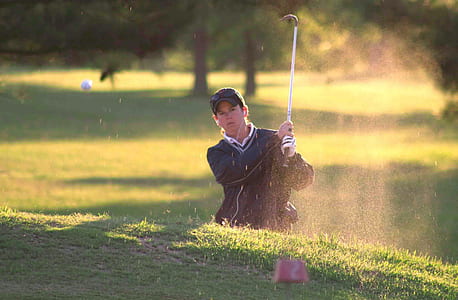 man playing golf during daytime in golf course thumbnail