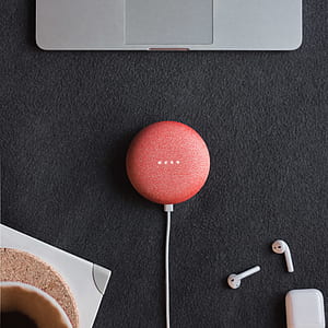 red Google Mini speaker on black cloth thumbnail