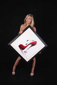 woman holding photo of red stiletto shoe thumbnail