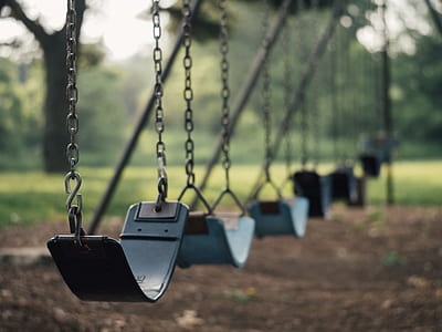 selective focus photography of gray metal swings thumbnail