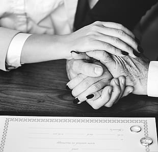 greyscale photo of two person holding hands thumbnail