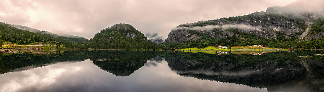 mountain reflecting on body of water thumbnail