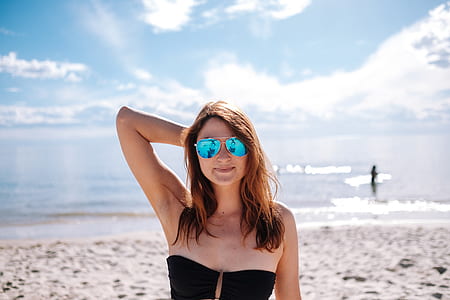 shallow focus photography of woman standing on seashore thumbnail