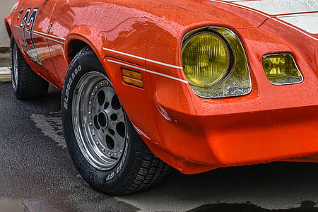 red and white coupe on gray concrete pavement thumbnail