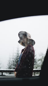 woman wearing sunday hat standing outside the car thumbnail