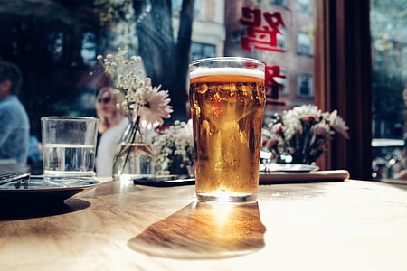 pint glass on table with brown liquid thumbnail