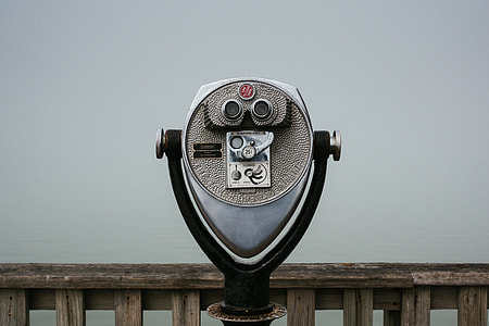 grey and black coin-operated telescope near brown wooden fence thumbnail