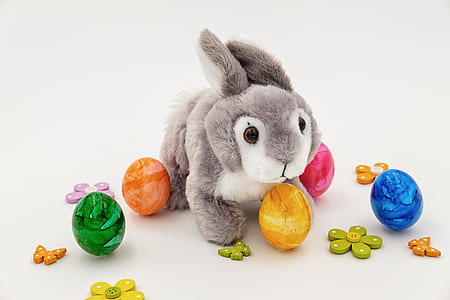 gray and white rabbit plush toy near egg toys thumbnail