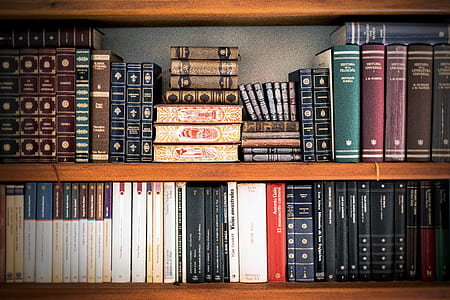 books on brown wooden shelf thumbnail