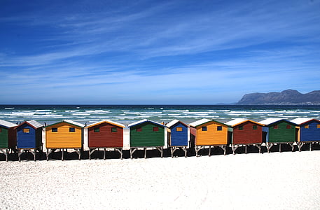 assorted-color of houses on seashore near island during daytime thumbnail