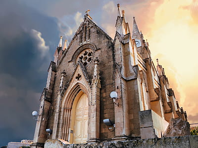 low angle photography of brown concrete church thumbnail