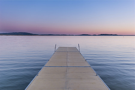 brown wooden dock on body of water at daytime thumbnail