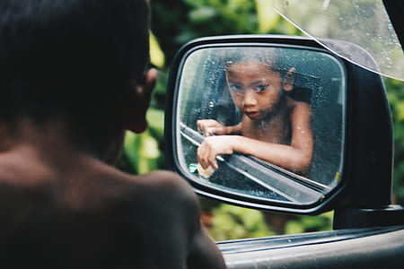 baby looking at vehicle's left side mirror thumbnail