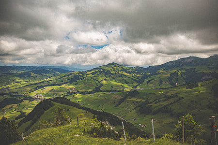 aerial view of mountain under cloudy skies thumbnail