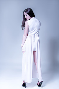 woman wearing white sleeveless long dress with slit and black heeled sandals thumbnail