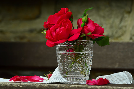 three red Rose flowers on clear cut glass thumbnail