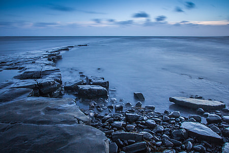 gray stone fragments on body of water thumbnail