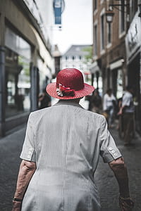 woman wearing red sun hat in street thumbnail
