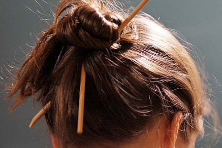 woman wearing brown sticks on hair thumbnail