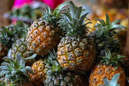 selective photography of piled pineapples thumbnail
