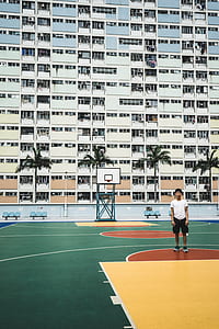 man standing on basketball court thumbnail