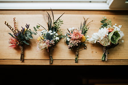four white flower bouquets on brown wooden panel thumbnail