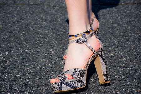 woman wearing black-and-gray leather heeled sandals thumbnail