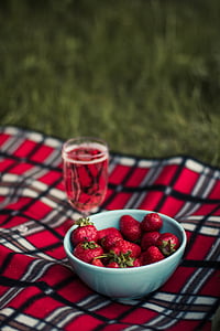 strawberries in white bowl on plaid textile in tilt shift photography thumbnail