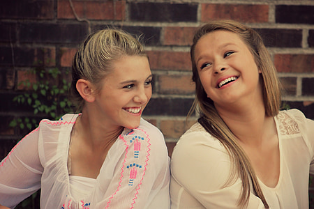 two girl wearing white scoop-neck shirts thumbnail