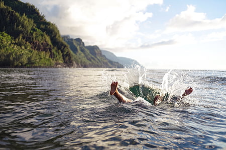 photo of person swimming in water thumbnail