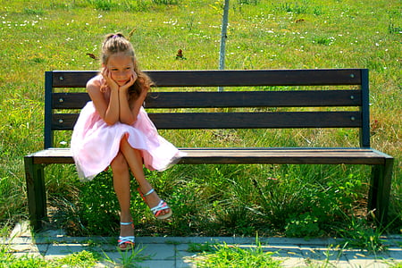 girl sitting on outdoor bench thumbnail