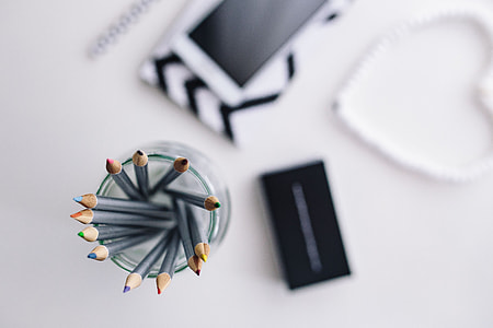 Black-and-white notebook and a white smartphone with various items thumbnail