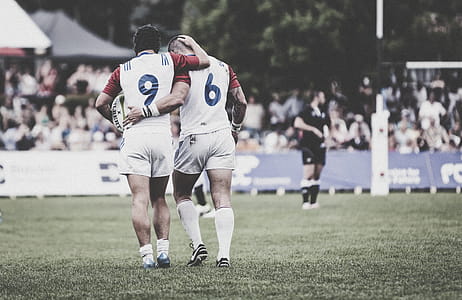 Two athletes Standing in a Field thumbnail