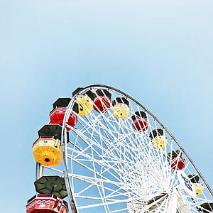 multicolored ferris wheel under cloudy sky thumbnail