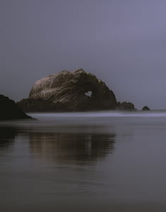 rock formation near body of water thumbnail
