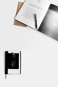 black pen on top of open book thumbnail