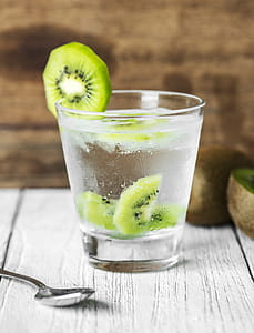 clear drinking glass with sliced kiwi fruit thumbnail