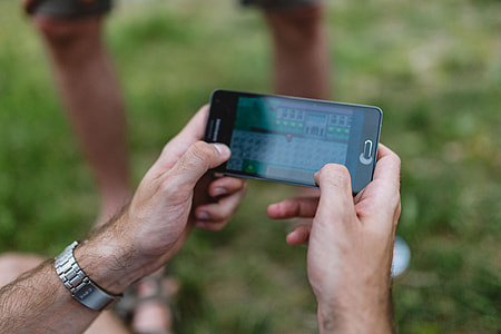Closeup of man hands playing videogames on cell phone thumbnail