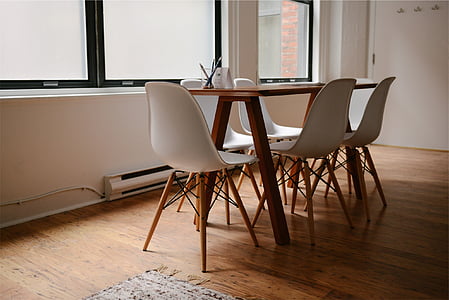 rectangular brown wooden dining table and white plastic chairs thumbnail