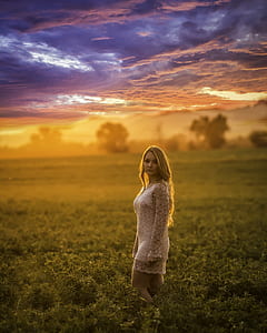woman standing on green grass field thumbnail