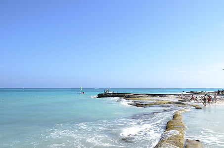 people walking on the seaside during daytime thumbnail