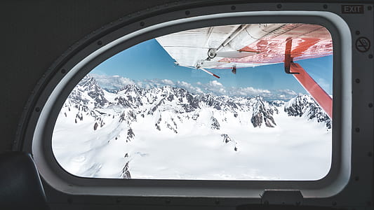 clear glass plane window displaying white snow covered mountain thumbnail