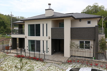 white concrete house beside tree thumbnail