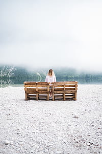 woman in white shirt sitting brown wooden bench during daytime thumbnail